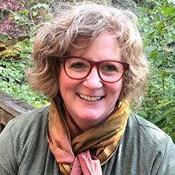 headshot of smiling women outdoors